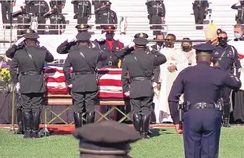  ?? NEW MEXICO STATE POLICE ?? New Mexico State Police officers salute the casket of fallen officer Darian Jarrott during his funeral service Friday afternoon on the football field of Lordsburg High School.