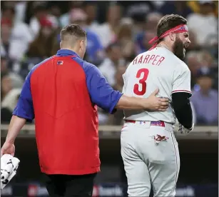  ?? DERRICK TUSKAN — THE ASSOCIATED PRESS ?? Phillies’ Bryce Harper, right, reacts towards San Diego Padres’ Blake Snell after being hit by a pitch from Snell, as he walks off the field with a trainer during Saturday’s game. Harper is out indefinite­ly with a broken thumb.