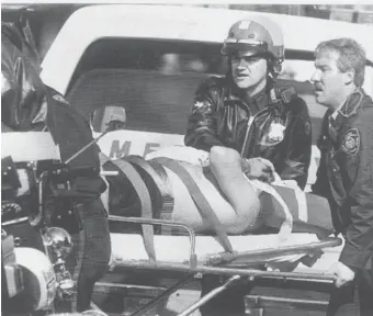  ?? BOSTON HERALD FILE ?? ‘SACRIFICE FOR THE CITY’: Officer Francis Foley is rushed to an ambulance in October 1991 after a bomb went off, seriously injuring Foley and killing his partner, Jeremiah Hurley.