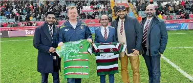  ?? ?? Officials exchange jerseys symbolisin­g the partnershi­p that took place during the halftime interval of the Gallagher Premiershi­p match between Tigers and Bath Rugby in front of 26,000 spectators