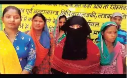  ??  ?? A video grab of a veiled woman who was made to stand (along with others) to read out from an off-camera script, thanking the Centre for the maternity benefits