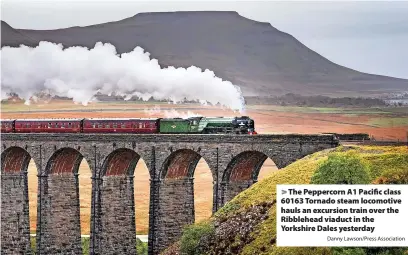  ?? Danny Lawson/Press Associatio­n ?? > The Peppercorn A1 Pacific class 60163 Tornado steam locomotive hauls an excursion train over the Ribblehead viaduct in the Yorkshire Dales yesterday