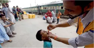  ?? Ruters ?? A boy receives polio vaccine drops at Cantonment Railway Station in Karachi on Monday. —