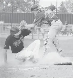  ?? Herald photo by Dale Woodard ?? Lethbridge Miner Nolan Walls beats the throw to the plate against Medicine Hat Knights catcher Zach Stark during action at the 18th annual Ron Matthews Memorial Tournament Friday afternoon at Spitz Stadium.