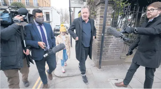  ?? JONATHAN BRADY/PA MEDIA ?? Piers Morgan speaks to reporters Wednesday outside his London home. Morgan quit the “Good Morning Britain” program Tuesday after making controvers­ial comments about Meghan in the wake of her interview this week with Oprah Winfrey.