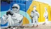  ?? PIC/PTI ?? A policeman wearing a PPE kit disinfects an area near Samta Nagar Police Station, in Mumbai, on Wednesday