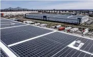  ?? TONY CENICOLA / THE NEW YORK TIMES ?? Photovolta­ic panels installed by Solar Landscape, a community solar developer, on warehouse roofs in Perth Amboy, N.J., on March 22.