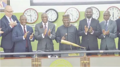  ??  ?? Abdul Samad Rabiu (3rd r), chairman, Cement Company of Northern Nigeria (CCNN); Oscar Onyema (3rd l), CEO, Nigeria Stock Exchange (NSE), and other directors of the CCNN, Finn Arnoldsen (l); Chimaobi Madukwe (2nd l); Kabiru Rabiu (2nd r), and Ahmed Aliyu, company secretary, CCNN, during the ringing of the closing gong on the floor of the NSE to mark the end of trading and commemorat­e the successful completion of the Ccnn/kalambaina Cement Merger in Lagos. Pic by Olawale Amoo