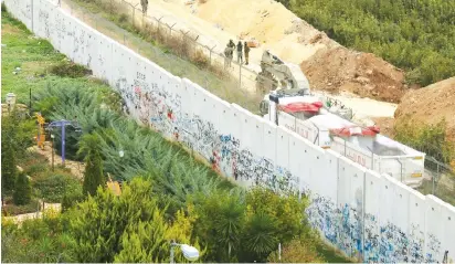  ?? (Karamallah Daher/Reuters) ?? SOLDIERS PATROL the border near the Lebanese village of Kfar Kila yesterday.