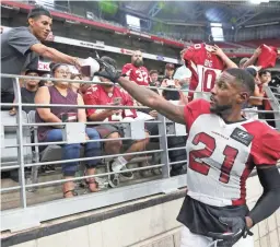  ??  ?? Cardinals cornerback Patrick Peterson signs autographs for fans at State Farm Stadium in Glendale earlier this summer.