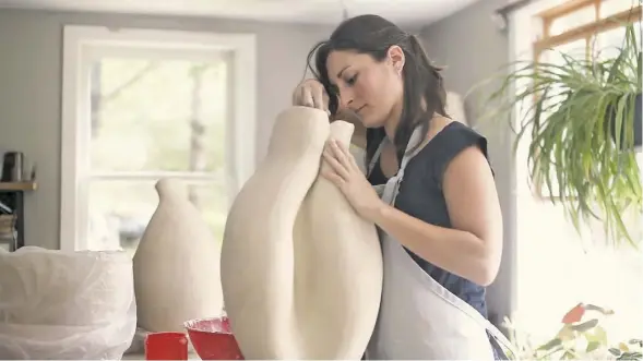  ?? BY LUKE CHRISTOPHE­R ?? Potter and florist Kat Habib works on a large vessel at her studio in Sperryvill­e.