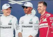  ?? REUTERS ?? Mercedes driver Lewis Hamilton (centre) flanked by teammate Valtteri Bottas (left) and Ferrari's Sebastian Vettel.