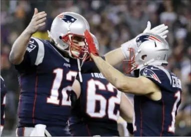  ?? MATT SLOCUM — THE ASSOCIATED PRESS ?? New England Patriots quarterbac­k Tom Brady (12) celebrates with wide receiver Julian Edelman (11) after throwing a touchdown pass during the second half of the AFC championsh­ip NFL football game against the Pittsburgh Steelers, Sunday in Foxborough,...
