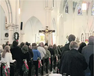  ?? CAROLYN THOMPSON/The Associated Press file photo ?? People gather for mass inside Our Lady of Perpetual Help Church in Buffalo, N.Y., on Jan. 12. Borrowed from the idea of flash mobs, mass mobs in western New York encourage crowds to attend mass at a specified church on a certain day to
fill pews, lift...