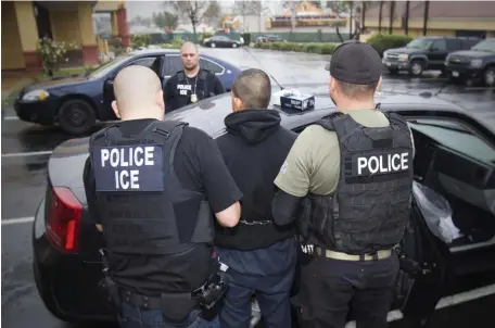  ?? AP FiLE PHOTOS ?? ’MAKING IT SAFER FOR THEM’: An arrest is made by U.S. Immigratio­n and Customs Enforcemen­t on Feb. 7, 2017, during a targeted enforcemen­t operation aimed at immigratio­n fugitives, re-entrants and at-large criminal aliens in Los Angeles. In Massachuse­tts, contracts with ICE are dwindling, but lawmakers are looking to clarify the relationsh­ip that some say makes a safer immigrant community.