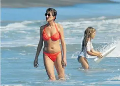  ?? Picture: Getty Images ?? Princess Diana in the surf off the island of Nevis during a Caribbean holiday in 1993. Jenni Rivett, left, was Diana’s personal trainer for several years.