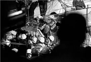  ?? ANTHONY VAZQUEZ/AP ?? Workers move debris Thursday at a school where they reportedly had searched for a missing girl dubbed “Frida Sofia.”