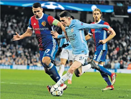  ??  ?? Tried hard: Phil Foden challenges Basel’s Marek Suchy on just his third start in the City midfield