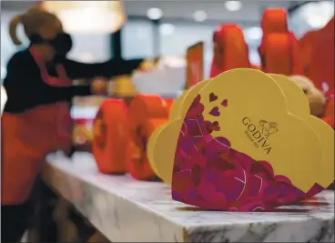  ?? ELIJAH NOUVELAGE — GETTY IMAGES ?? Godiva, the luxury chocolatie­r, will close all 128 of its brick-and-mortar stores in North America by the end of March citing the COVID-19 pandemic. The company will keep open its stores in Europe, the Middle East and China.