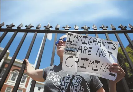  ?? STAFF PHOTOS, ABOVE, BY NANCY LANE; TOP, BY PATRICK WHITTEMORE ?? SPEAKING OUT: Amy Mertl of Somerville, above, holds a sign at a protest outside the State House against President Trump’s border policy. Gov. Charlie Baker, top, was dragged into the dispute by Democrats.