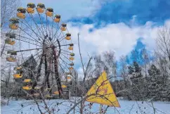  ??  ?? Nuclear chill: the yellow cabins of the Ferris wheel at Chernobyl’s unused fairground stand mute witness to the horrors of the explosion