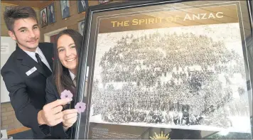  ??  ?? DIMMY SPIRIT: Dimboola Memorial Secondary College captains Tristan Rayes and Danni Haebich display a famous First World War photograph during an Anzac Day service at the college. Pictures: PAUL CARRACHER.