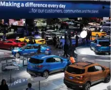  ?? AFP/GETTY IMAGES ?? People visit the Ford stand during a media preview at the 2018 North American Internatio­nal Auto Show in Detroit last month.