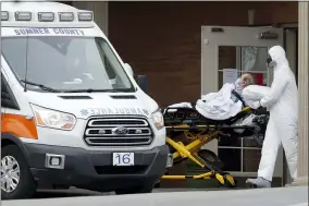  ?? MARK HUMPHREY — THE ASSOCIATED PRESS ?? A resident is removed from the Gallatin Center for Rehabilita­tion and Healing, Monday, March 30, in Gallatin, Tenn. Multiple people tested positive for the coronaviru­s at the facility last Friday.