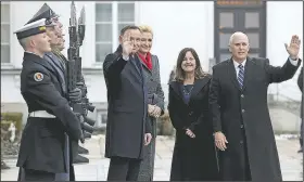  ?? AP/MICHAEL SOHN ?? U.S. Vice President Mike Pence (right) waves as he and his wife, Karen Pence, are welcomed by Poland’s President Andrzej Duda (center left) and his wife, Agatha Kornhauser-Duda, at Belvedere palace in Warsaw, Poland, on Wednesday.