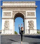  ??  ?? Syrian dancer and choreograp­her Yara Al-Hasbani performs a dance in front of Paris’ Arc de Triomphe.