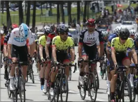 ??  ?? The peloton rides along East Shoreline Drive during the first stage of the Amgen Tour of California cycling race, on Sunday, in Long Beach. AP Photo/Ringo H.W. CHIU
