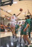  ?? ?? The Taos Tigers Xavier Duke attempts a jump shot during a home game against the Moriarty Pintos on Monday (Jan. 31).