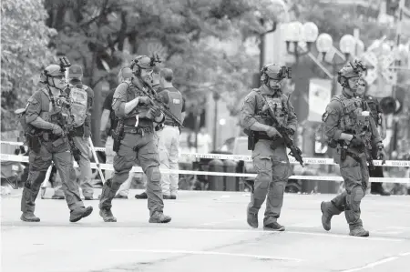  ?? NAM Y. HUH AP ?? Police converge after a mass shooting at a Fourth of July parade in the Chicago suburb of Highland Park, Illinois, on Monday.