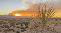  ?? MATT DAHLSEID/NEW MEXICAN FILE PHOTO ?? The sun sets Sunday evening behind a plume of smoke from the Black Feather Fire in the Santa Fe National Forest.