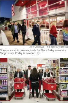  ?? JOHN MINCHILLO — THE ASSOCIATED PRESS ?? Shoppers wait in queue outside for Black Friday sales at a Target store, Friday in Newport, Ky.
