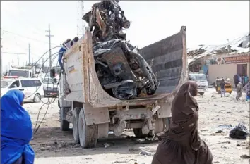  ?? Farah Abdi Warsame/Associated Press ?? A truck carries wreckage of a car used in a car bomb Saturday in Mogadishu, Somalia.