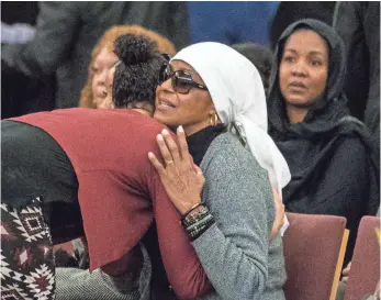  ?? ISAIAH J. DOWNING, IUSA TODAY SPORTS ?? A mourner greets Rashaan Salaam’s mother, Khalada, during funeral services for the 1994 Heisman Trophy winner in Boulder, Colo., on Dec. 9. Rashaan Salaam committed suicide Dec. 5.