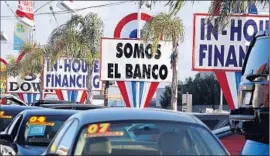  ?? Gary Friedman
Los Angeles Times ?? BUY HERE PAY NOW auto dealers target low-income customers with poor credit. Above, used cars for sale in Hawthorne in 2011.