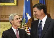  ?? SUSAN WALSH / ASSOCIATED PRESS 2013 ?? James Comey (right) talks with then-outgoing FBI Director Robert Mueller in 2013. President Trump has recently criticized both.