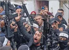  ?? (AFP) ?? Palestinia­n fighters take part in the funeral of Palestinia­n teenager Mahdi Hashash in Nablus on Wednesday.