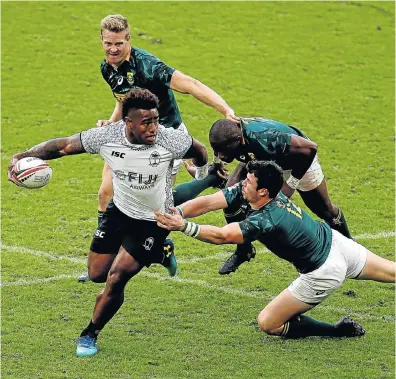  ?? Picture: JORDAN MANSFIELD/GETTY IMAGES ?? SLIPPERY CUSTOMER: Josua Tuisova, of Fiji, avoids a tackle from Ruhan Nel, of South Africa, on day two of the HSBC London Sevens at Twickenham in London yesterday