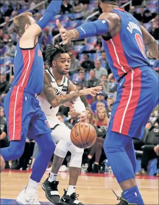  ?? AP ?? PASS, FAIL: D’Angelo Russell, who played 25 minutes — but none in the fourth quarter — passes between the Pistons’ Luke Kennard and Andre Drummond during Wednesday’s season-opening loss for the Nets.