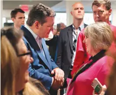  ?? Tyler Morning Telegraph via AP ?? ■ U.S. Sen. Ted Cruz shakes hands with Cindy Ward on April 2 during a re-election campaign stop in Tyler, Texas, at John Soules Foods. The Texan is seeking re-election to the U.S. Senate by pledging to repeal Barack Obama’s signature health care law,...