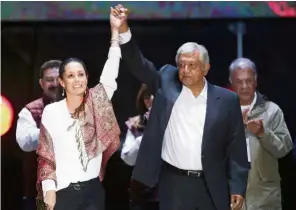  ?? — Reuters ?? Allies: Obrador holding up Sheinbaum’s (left) hand in support during the closing of his political rally in Mexico City.