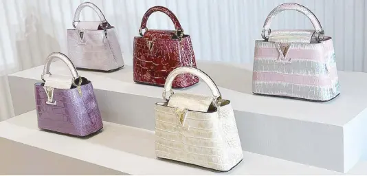  ?? ?? Louis Vuitton City Steamer, Petite Malle and Capucines bags in Sahara natural crocodile leather
Iconic Capucines bags in varying exotic skins and finishes