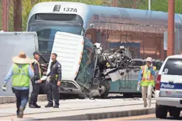  ?? PATRICK BREEN/THE REPUBLIC ?? Police say that a commercial truck was slammed by a southbound light-rail train at Clarendon Avenue after the truck tried to take a left turn. Three people were injured in the collision.