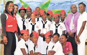  ?? CONTRIBUTE­D ?? Principal Eddie Whyte (back row, second left), Red Cross representa­tives and staff advisers share lens time immediatel­y after the Red Cross Youthlink Enrolment Ceremony in 2016.