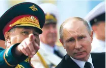  ?? ALEXANDER ZEMLIANICH­ENKO/POOL VIA AP ?? Russian President Vladimir Putin, right, watches a military parade with Defense Minister Sergei Shoigu Sunday during Russia’s Navy Day in St. Petersburg, Russia. Putin announced that the U.S. diplomatic mission in Russia must reduce its staff by 755...