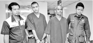  ??  ?? The two Thai nationals sentenced to jail after they admitted to keeping wire snares and a protected wildlife last month. - Bernama photo