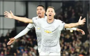  ?? GLYN KIRK/AFP ?? Manchester United midfielder Nemanja Matic (centre) celebrates scoring his side’s late winner against Crystal Palace on Monday night.